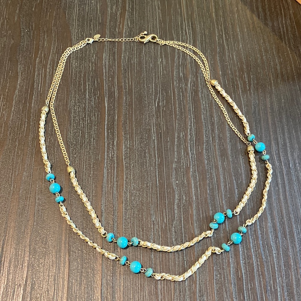 Lia Sophia gold tone necklace with teal blue beads and leather accents.